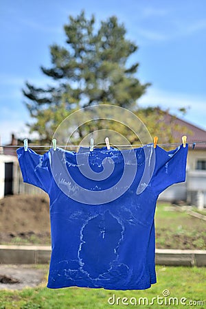 White salty sweat stains on blue clothes Stock Photo