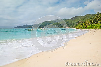 Palm trees, white sand and turquoise sea at Fairyland Beach, Seychelles Africa. Editorial Stock Photo