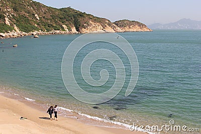 Couple at white sandy beach at Cheung Chau Island, Hongkong Editorial Stock Photo