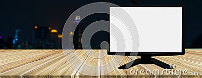 White screen computer placed on wooden table, blurred background night cityscape,empty space for text and images, copy space,use Stock Photo