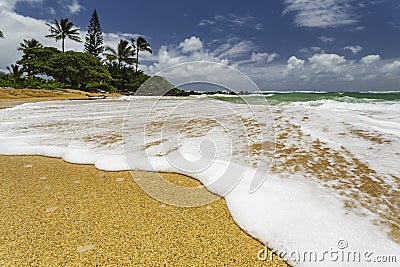 White sea foam washing up on shore Stock Photo