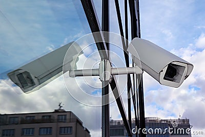 White security cctv camera on glass wall Stock Photo