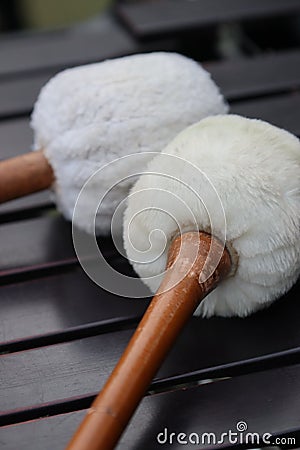 White sherpa and fur gong mallets on marimba Stock Photo