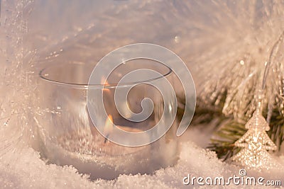 White shining decorations with a candle on the christmas tree. Stock Photo