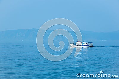 The white ship sails on lake Baikal. Stock Photo