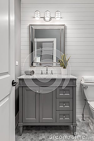 White shiplap bathroom with a grey vanity. Stock Photo