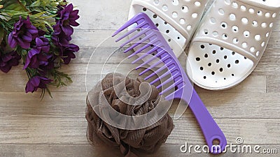 Bath Slippers, Rake Comb, Bath Spongeq and Flowers. Stock Photo