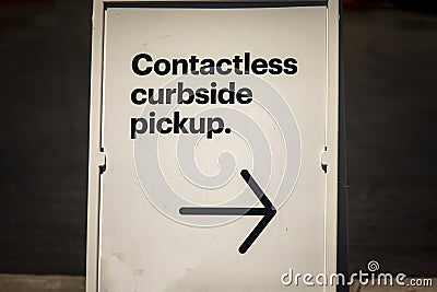 Sign advertising Contactless Curbside Pickup at retail store parking lot Stock Photo