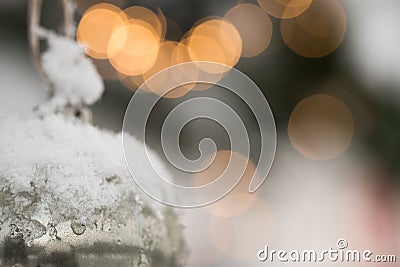 White Silver Beautyful Christmas Ornament Bauble haning at a Fir Tree with Snow Stock Photo