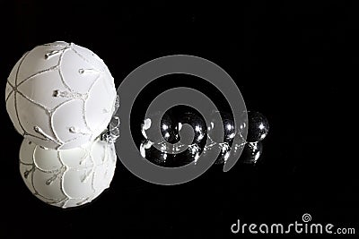 White silver christmas decorative balls over mirror reflected reverberation on dark black background. To write 2019 on Stock Photo