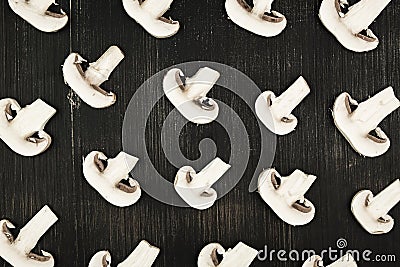 White sliced mushrooms on black wood rustic background, top view Stock Photo