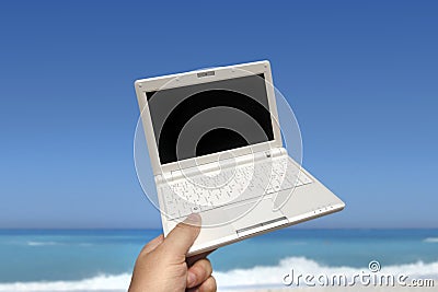 White small Laptop on the beach Stock Photo