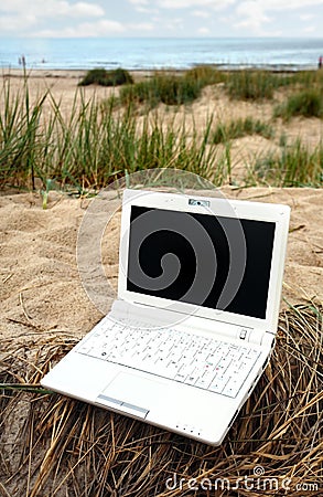 White small Laptop on the beach Stock Photo