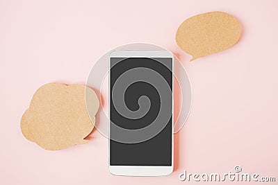 White smart phone with clipping path on touchscreen , couple of blank grunge brown bubble speech paper on sweet pink background Stock Photo