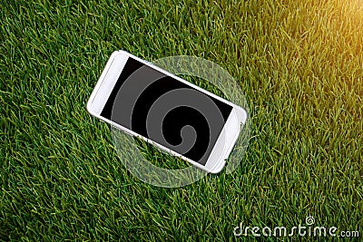 White smartphone with screen on fake grass Stock Photo