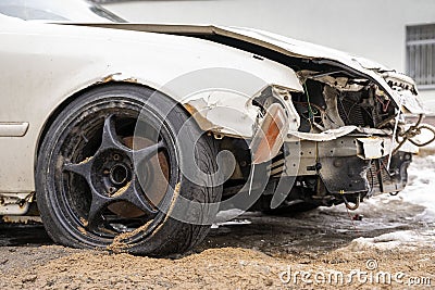 white smashed sedan with black wheels with damaged headlights, hood and bumper Stock Photo