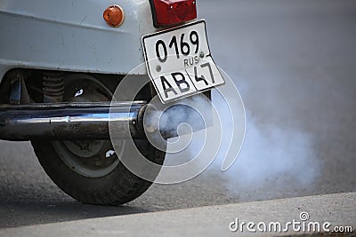 White smoke coming from the exhaust pipe of a scooter, close-up Editorial Stock Photo