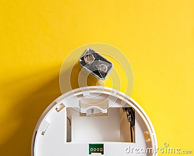 White smoke detector with nine volt battery Stock Photo