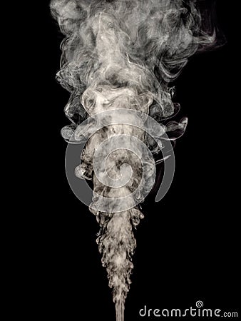 White smoke rises in a thick stream isolated on a black Stock Photo