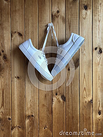 White sneakers on a wood background Stock Photo