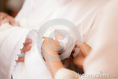 White sock on babys foot with mother hands taking care of child Stock Photo