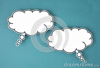 The White speech bubble shaped post it note on green background with copy space Stock Photo