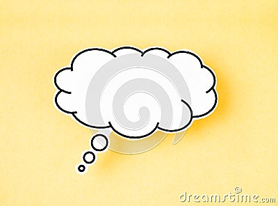 The White speech bubble shaped post it note on yellow background with copy space Stock Photo