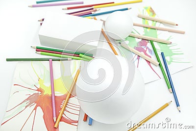 White spheres and prism with colored pencils and abstract paints on white background Stock Photo