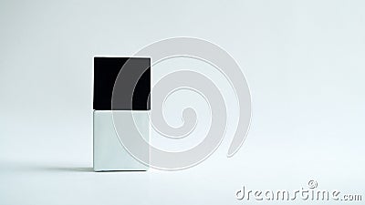 White square bottle with a black cap on a white background. Stock Photo