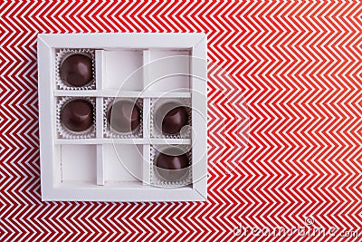 White square box with round chocolate candies. Stock Photo