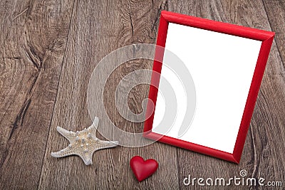 White starfish, heart and photo frame on a wooden background Stock Photo