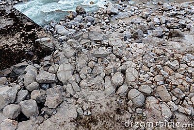 White stone ground wrapped with iron wire mesh for safety at Thangu and Chopta valley in winter in Lachen. North Sikkim, India Stock Photo