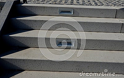 white stone staircase to an arch with backlighting of individual stair surfaces Stock Photo