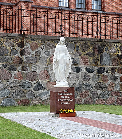 White stone statue of a woman near the Sacred Heart Cathedral in the Latvian city of Rezekne. July 2019 Editorial Stock Photo