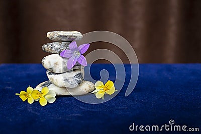 White stones stack on blue velvet and brown courtains Stock Photo