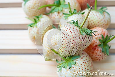 White strawberry , Pineapple Strawberry on wooden ,selective focus Stock Photo