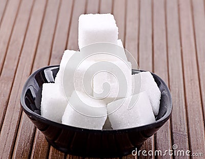Sugar cubes in a black saucer Stock Photo