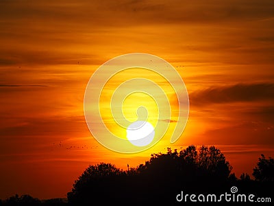 Sun with multicolored background over lake ivars and vila sana, lerida, spain, europe Stock Photo