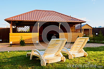 White sunbed in the garden with small house. Conctpt of summer rest outdoors Stock Photo