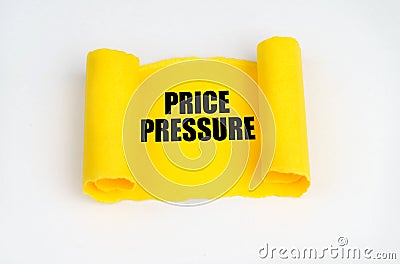 On a white surface, a yellow scroll of paper with the inscription - Price Pressure Stock Photo