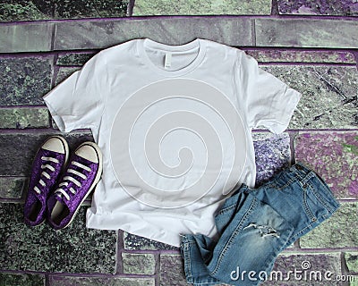 White T Shirt mockup flat lay on purple brick background with pu Stock Photo