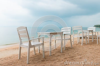 Romantic cafe with white tables and chairs on the sea shore Stock Photo