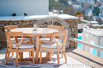 White tables with chairs at summer empty open air cafe in luxury hotel Stock Photo