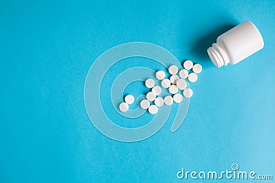 White tablets in plastic container top view Stock Photo