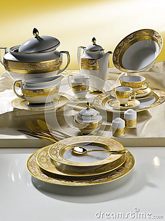 White tableware set with gold trim Stock Photo