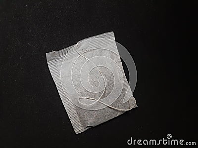 A white unused tea bag on black background Stock Photo