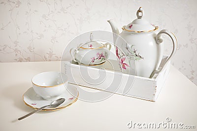 White tea service on white commode ready for use. Start a morning with cup of tea or coffee Stock Photo