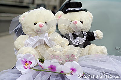 Bride and groom Teddy wedding bears attached to the car Stock Photo