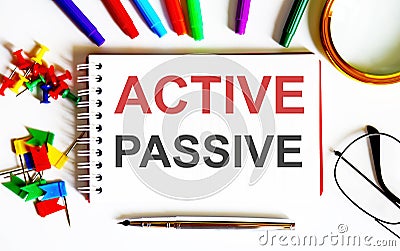 White text PASSIVE ACTIVE on the notepad , multi-colored felt-tip pens Stock Photo