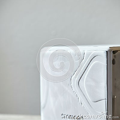 White textured cube with subtle geometric patterns on the surface, partially visible on Stock Photo